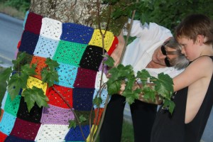 My mother-in-law, Tracey, and my son, Rubin, putting up a funky granny square piece.